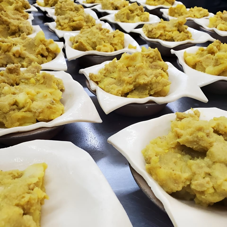 Rows of small, individual Bula Pies Fiji pastries filled with a golden, savory potato mixture.
